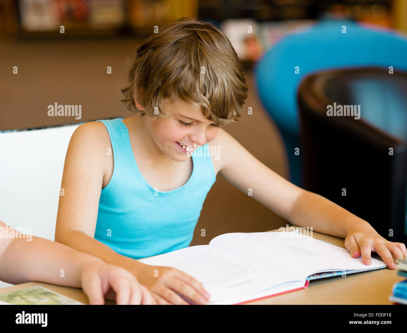 Boy in library with books Stock Photo - Alamy