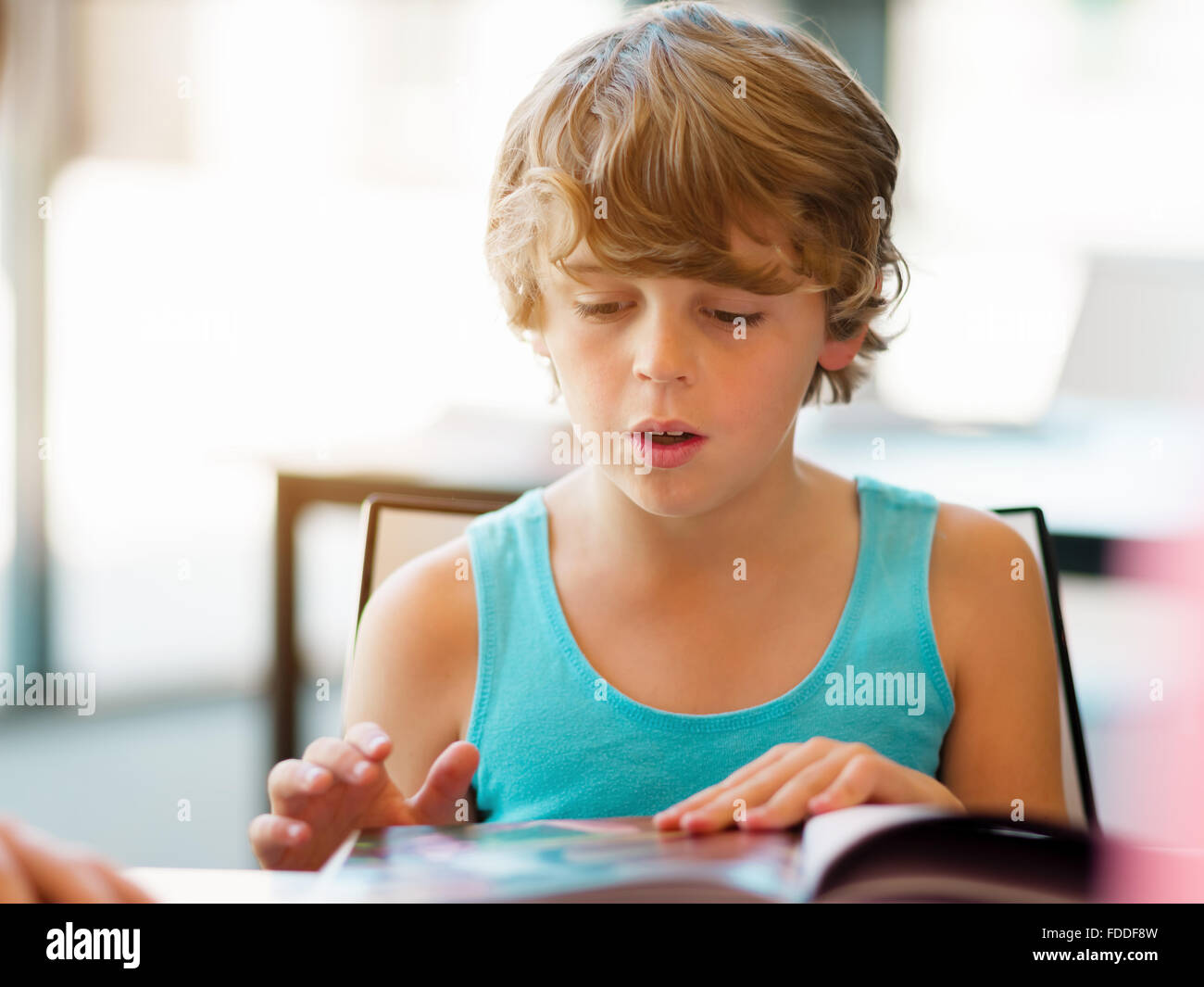Boy in library with books Stock Photo - Alamy