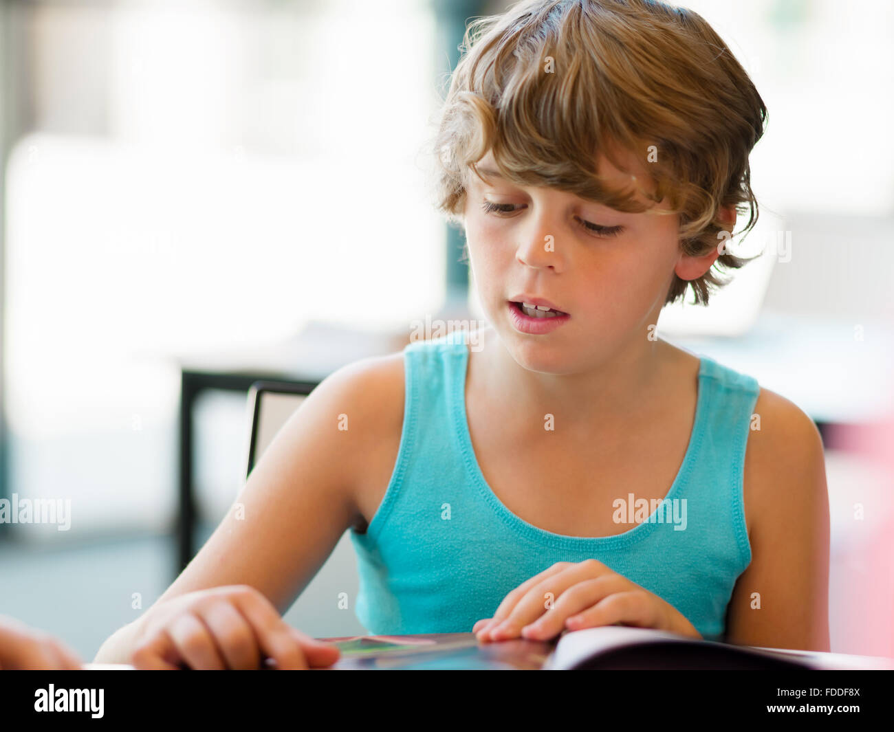 Boy in library with books Stock Photo - Alamy