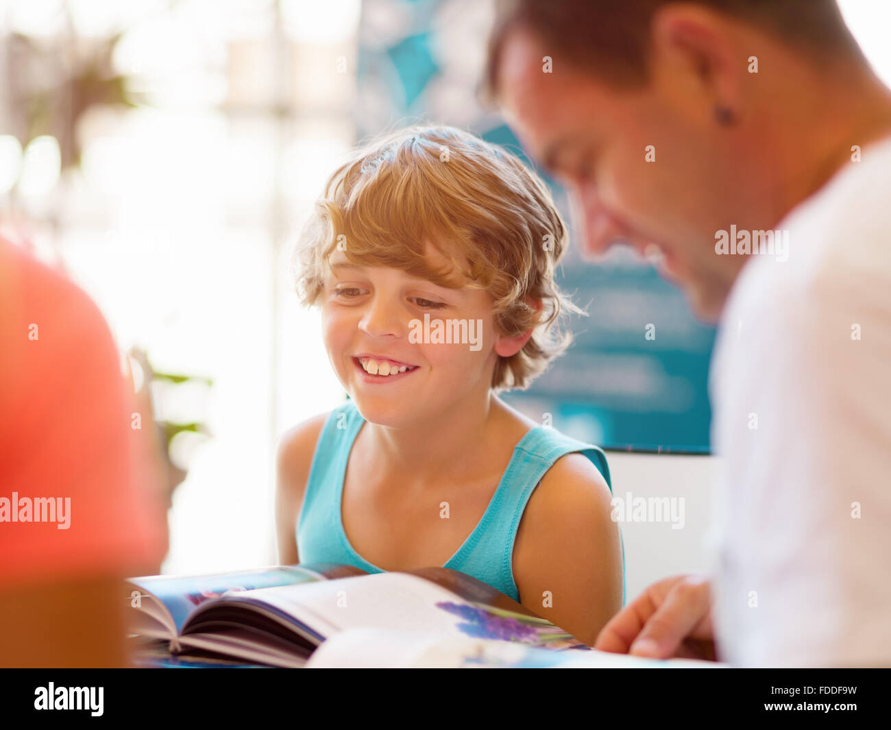 Boy in library with books Stock Photo - Alamy