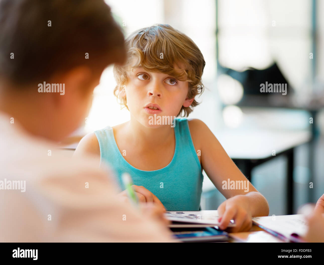 Boy in library with books Stock Photo - Alamy