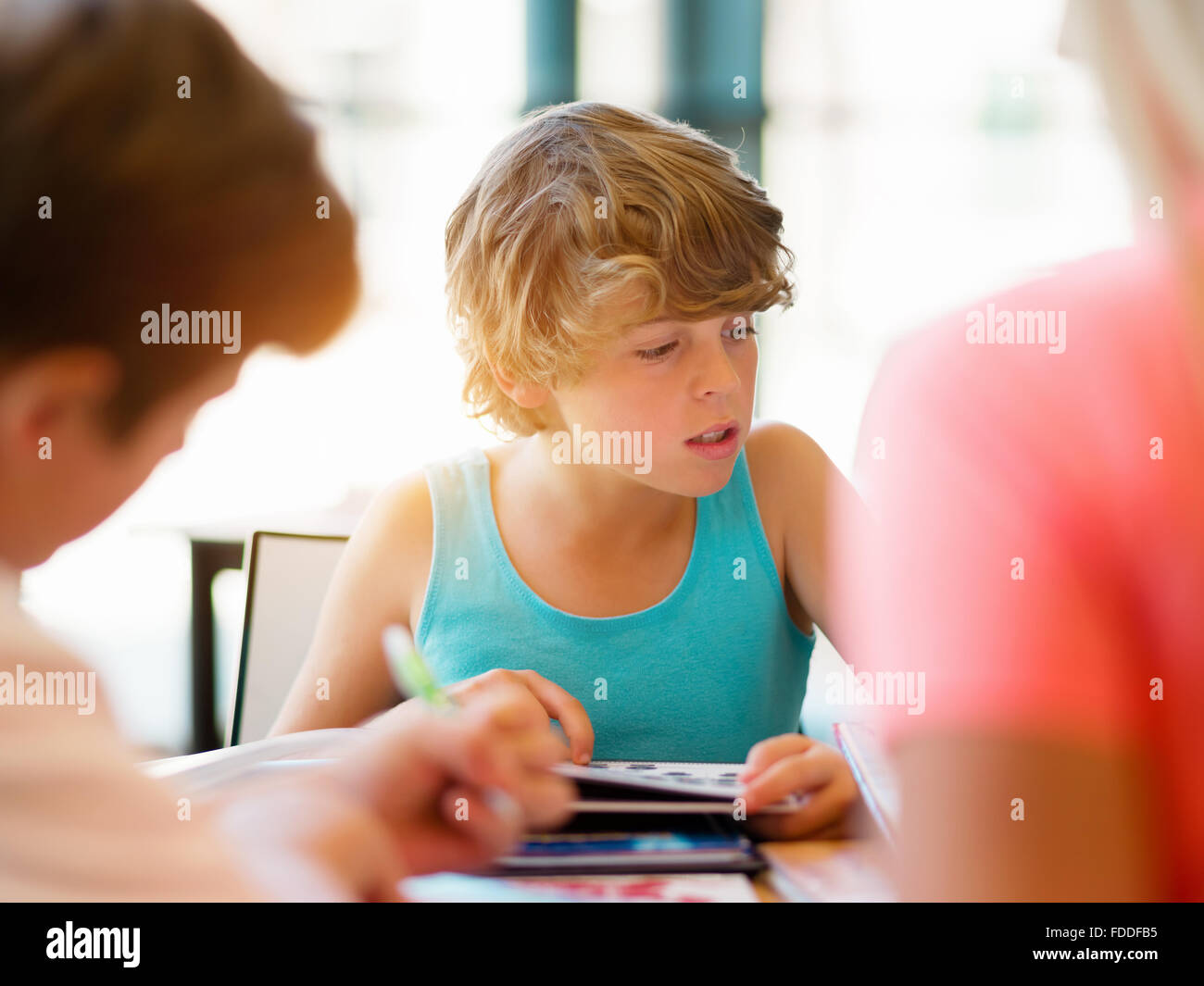 Boy in library with books Stock Photo - Alamy