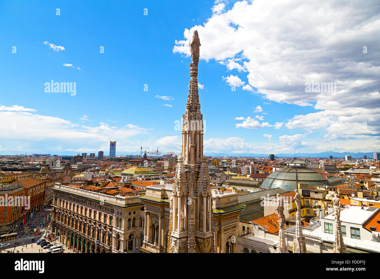 A statue of the Dome of Milan cathedral with the city view in summer. Stock Photo