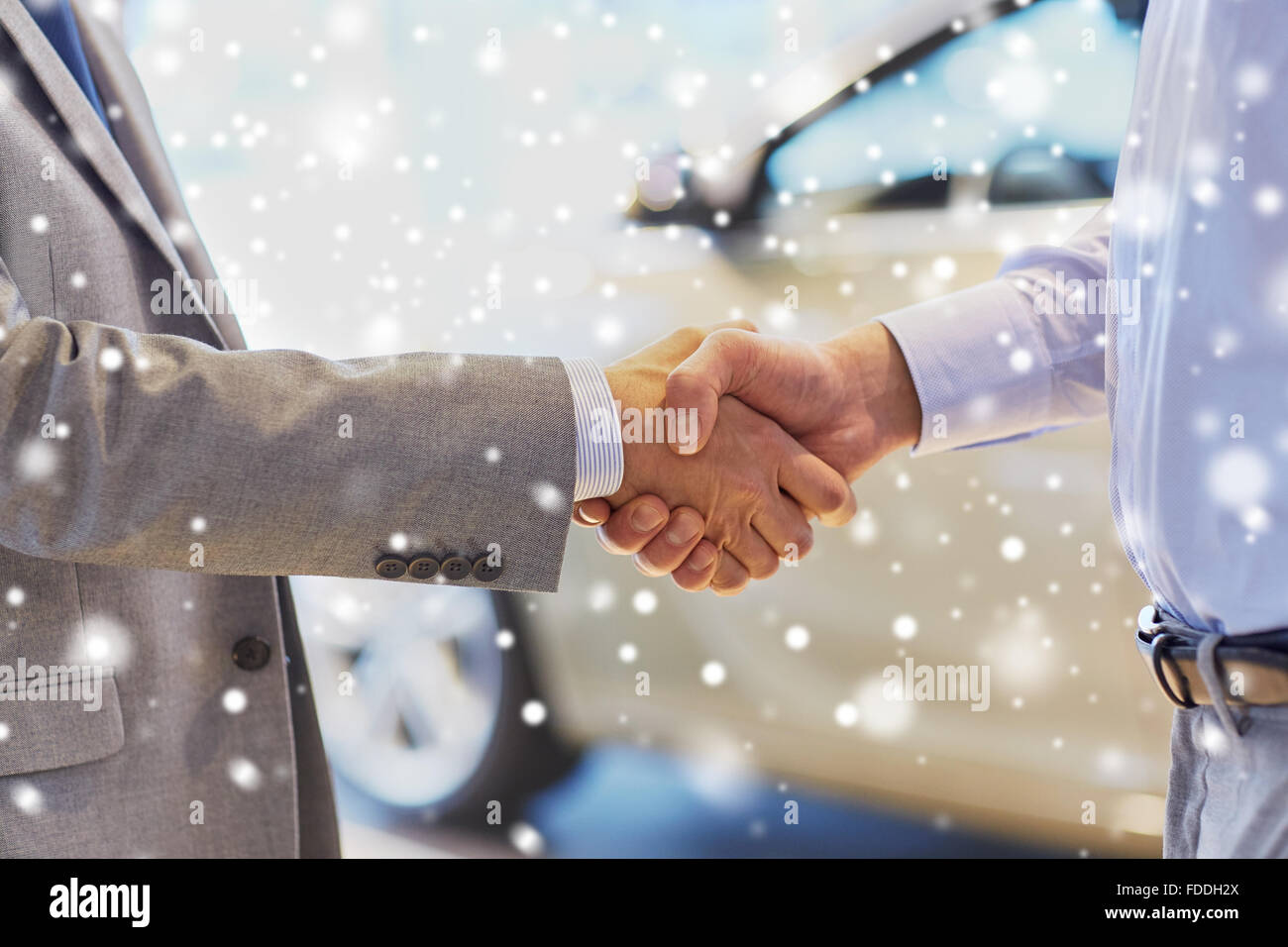 close up of male handshake in auto show or salon Stock Photo
