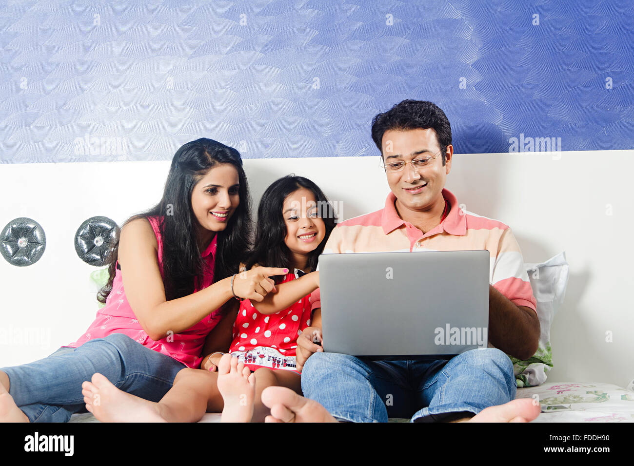 3 People Parents and Kid Daughter Laptop Chatting Finger Pointing Showing Stock Photo