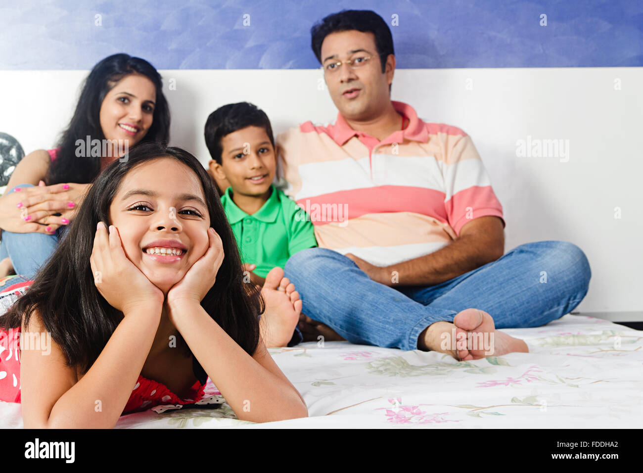 4 People Parents and Kid Bedroom Lying Down Relaxation Stock Photo