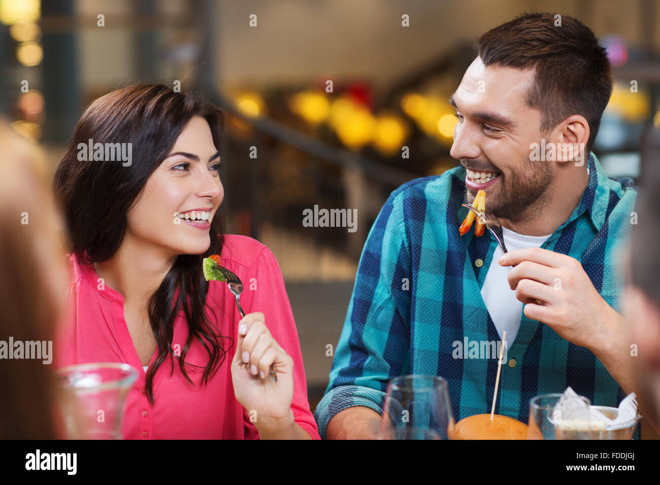 happy friends having dinner at restaurant Stock Photo