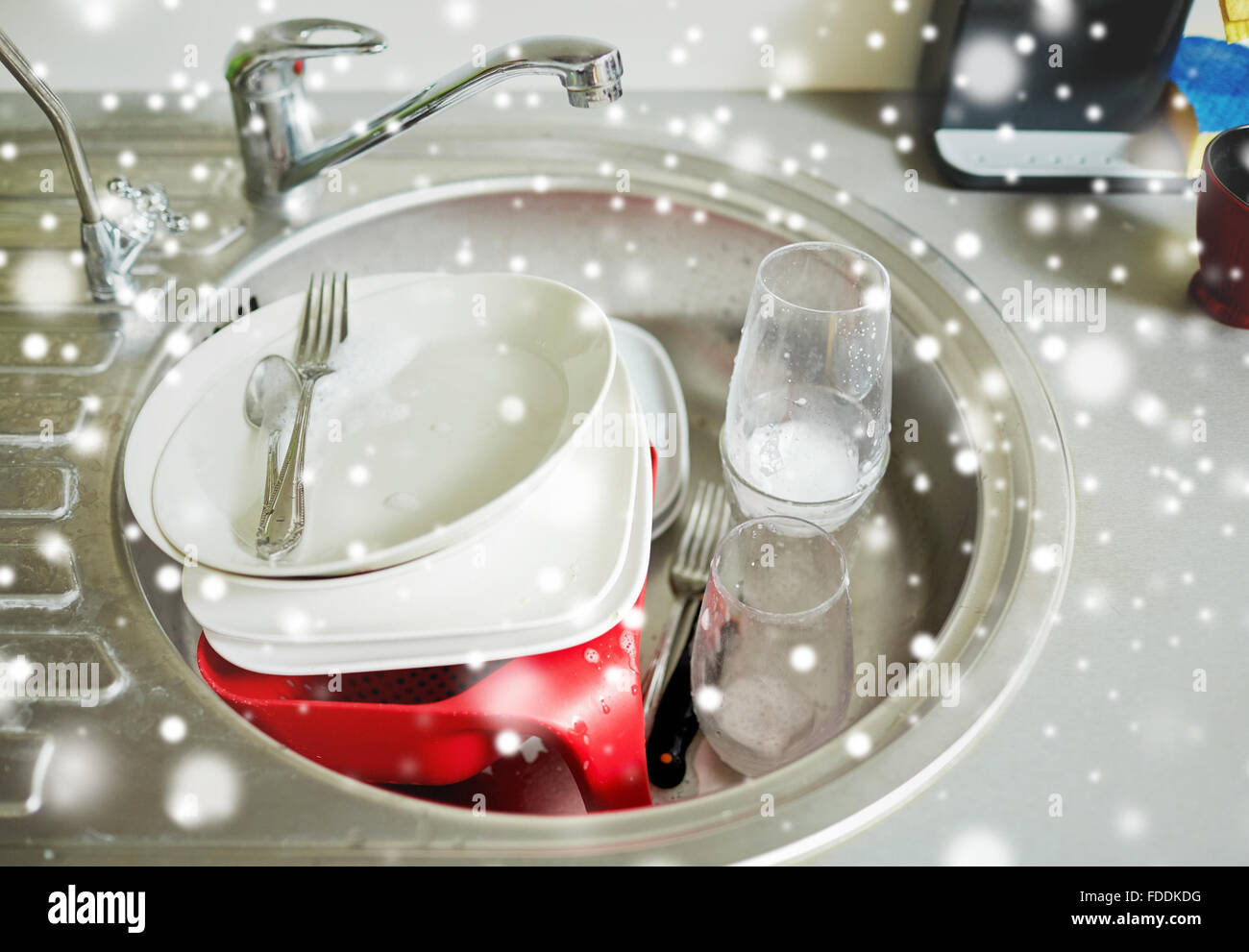 close up of dirty dishes washing in kitchen sink Stock Photo