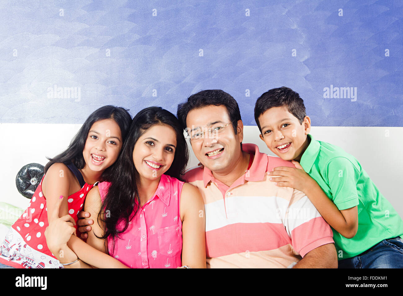 4 People Parents and Kid Bedroom Sitting Relaxation Stock Photo