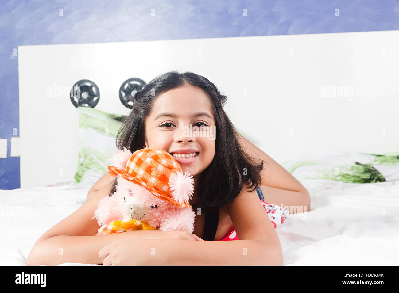Girl lying on bed with toy hi-res stock photography and images - Alamy
