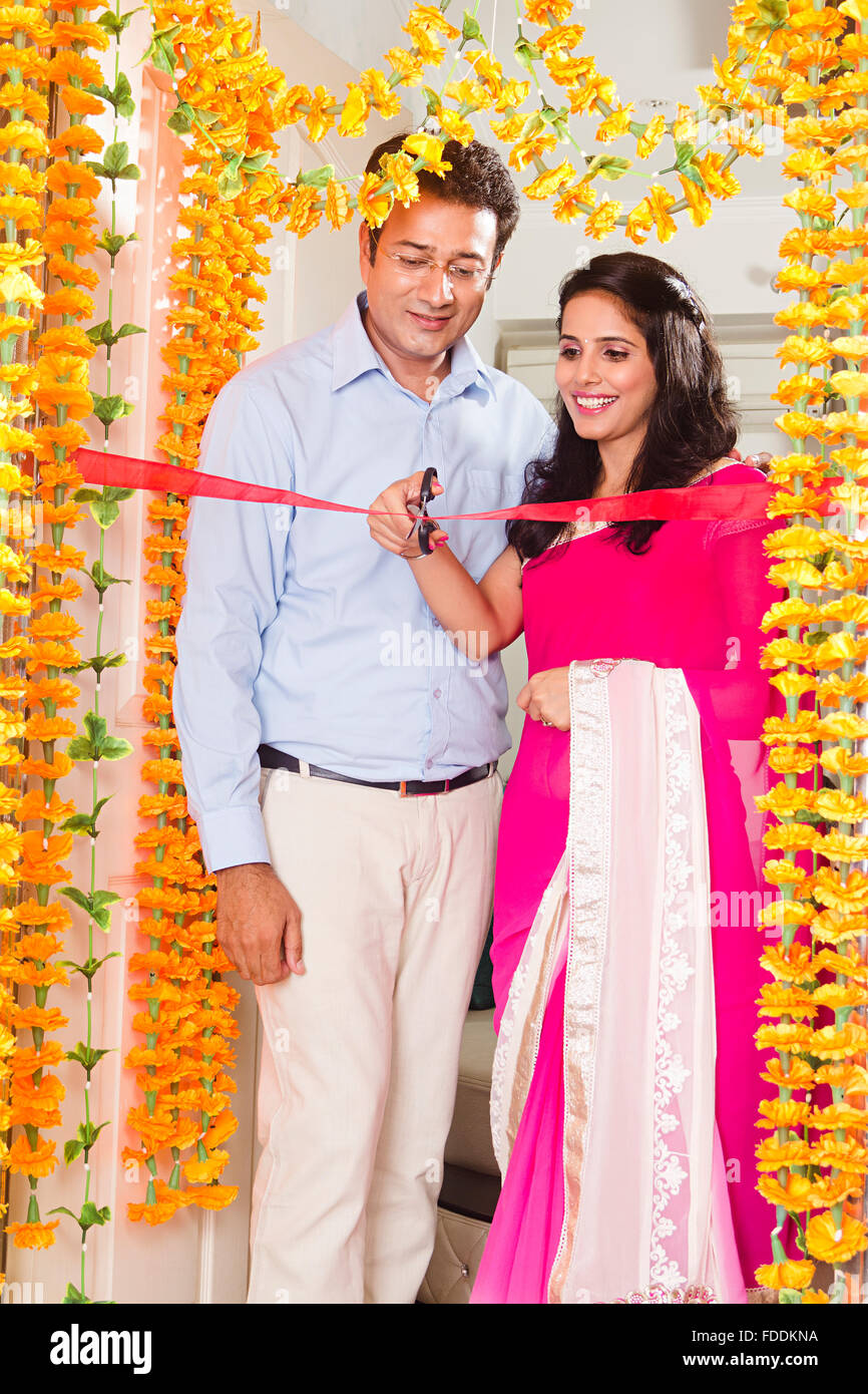 2 Married Couples Husband and wife House Grihapravesh Ribbon Cutting Stock Photo