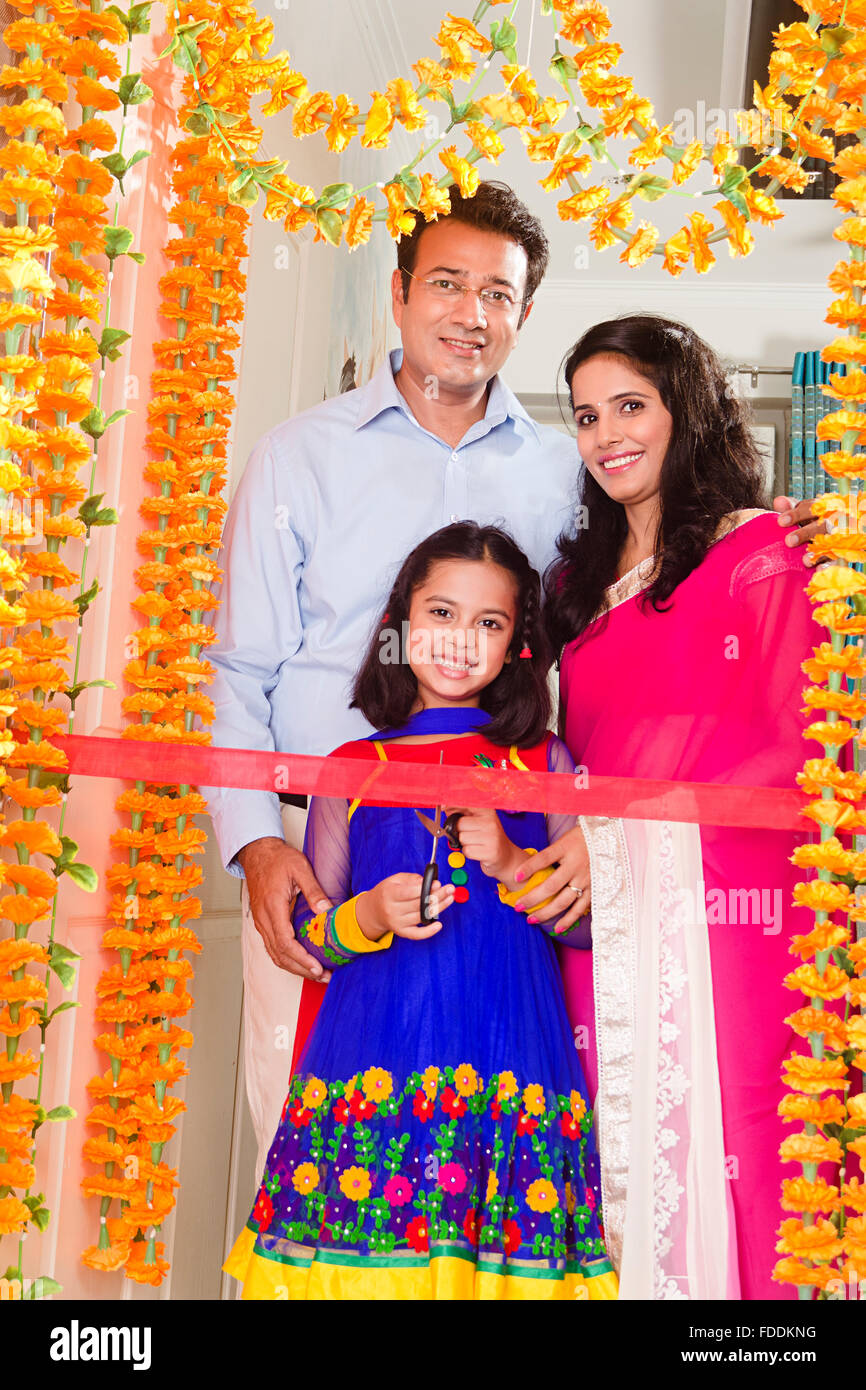 3 People Parents and Kid Daughter House Grihapravesh Ribbon Cutting Stock Photo