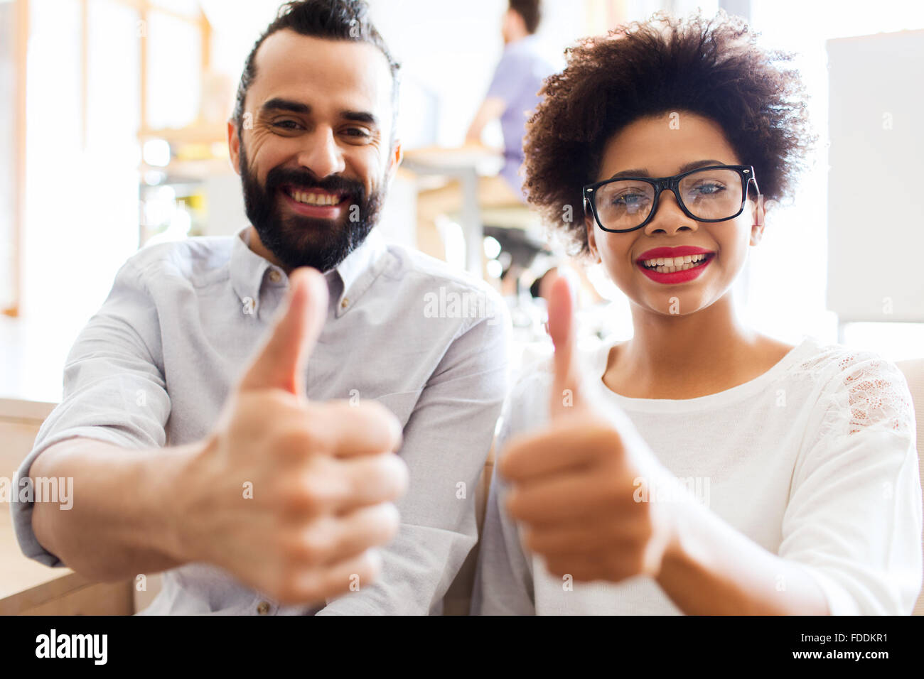 happy creative team in office showing thumbs up Stock Photo - Alamy