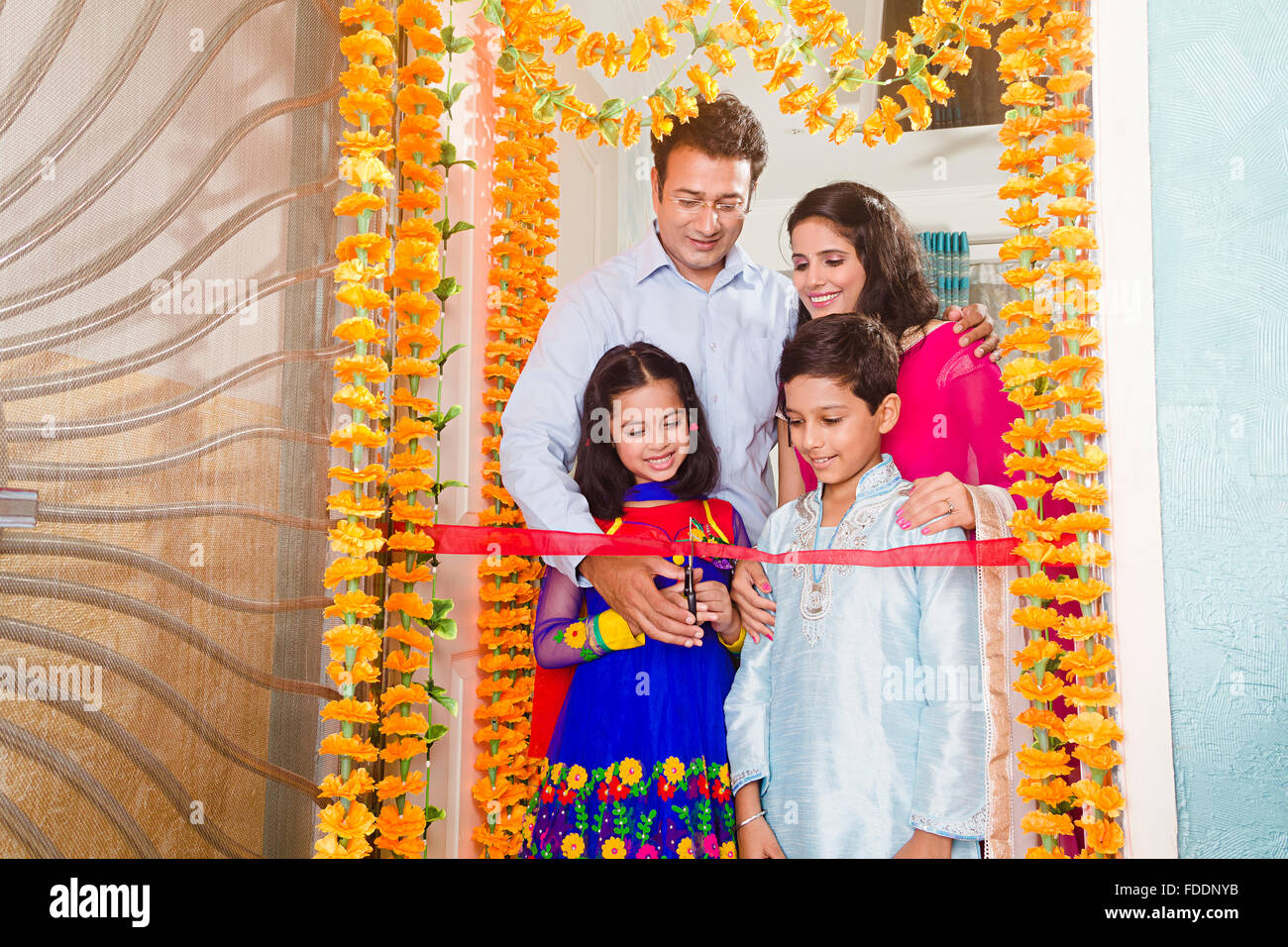 4 People Parents and Kid House Grihapravesh Ribbon Cutting Stock Photo