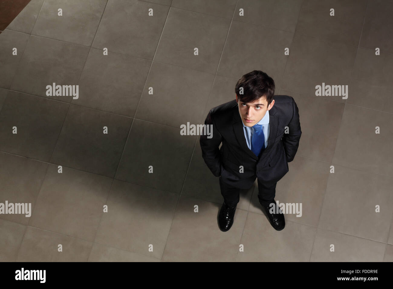Image of young businessman looking above. Top view Stock Photo - Alamy