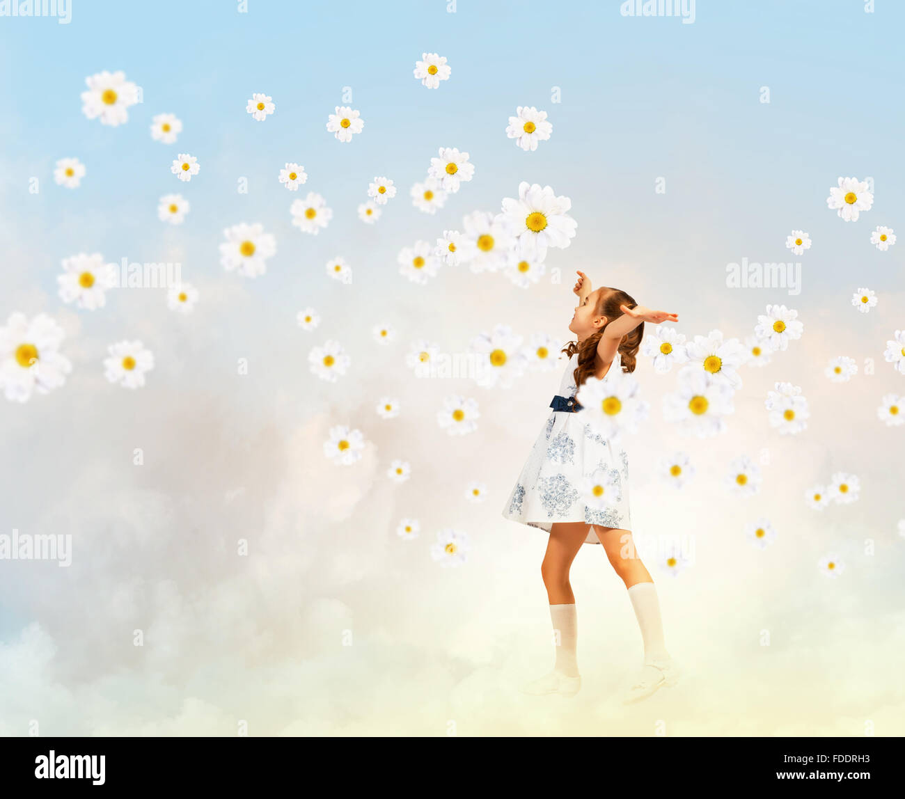 Image of little pretty girl playing among chamomiles Stock Photo - Alamy
