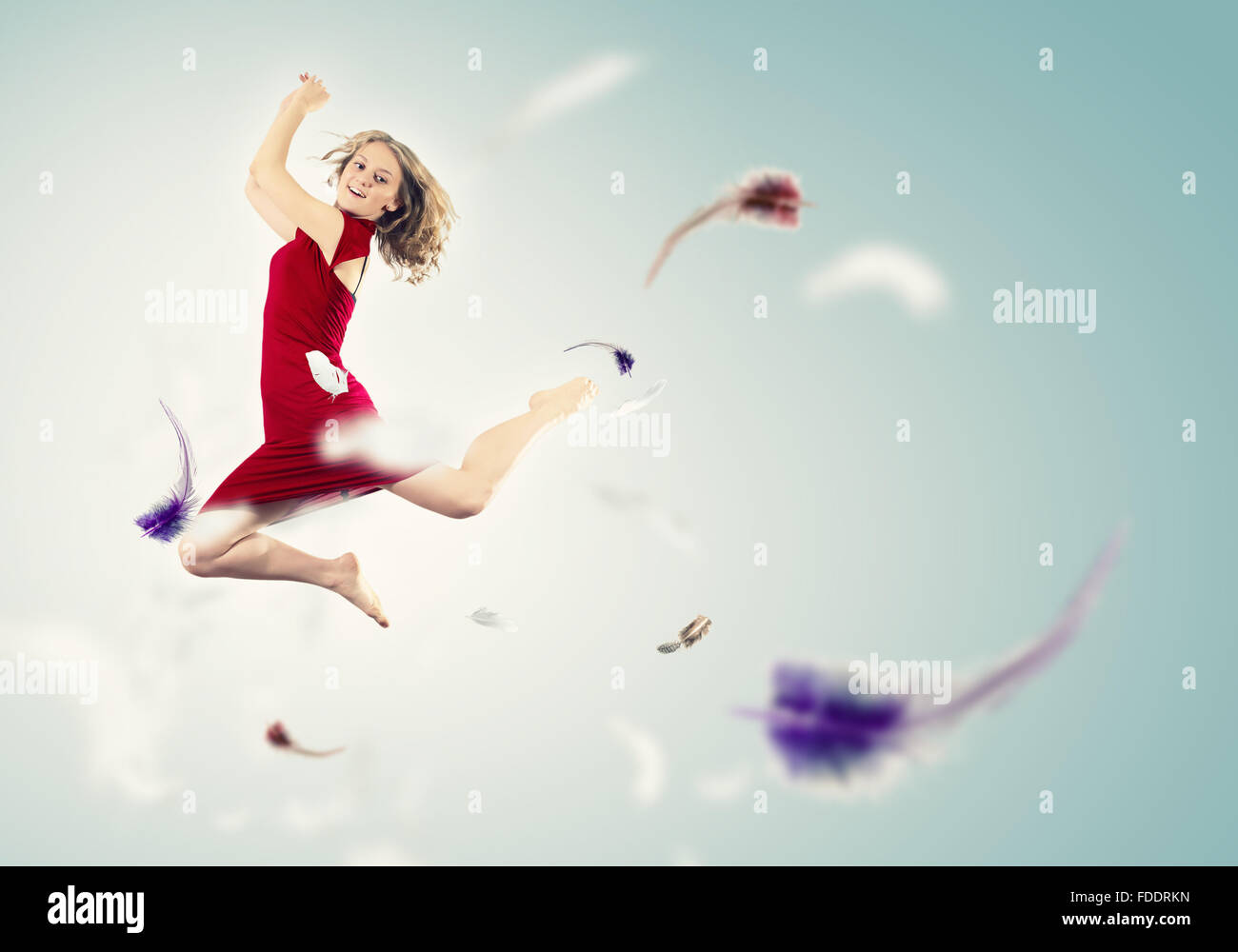 Young girl flying among the feathers like a bird Stock Photo - Alamy