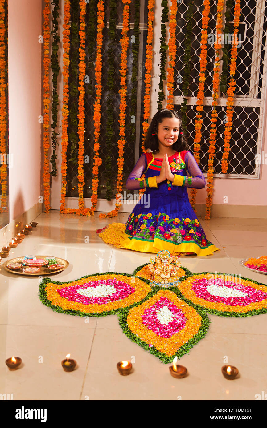 1 kid girl Diwali Festivals Home Rangoli Decoration and Joined hands Welcome Stock Photo