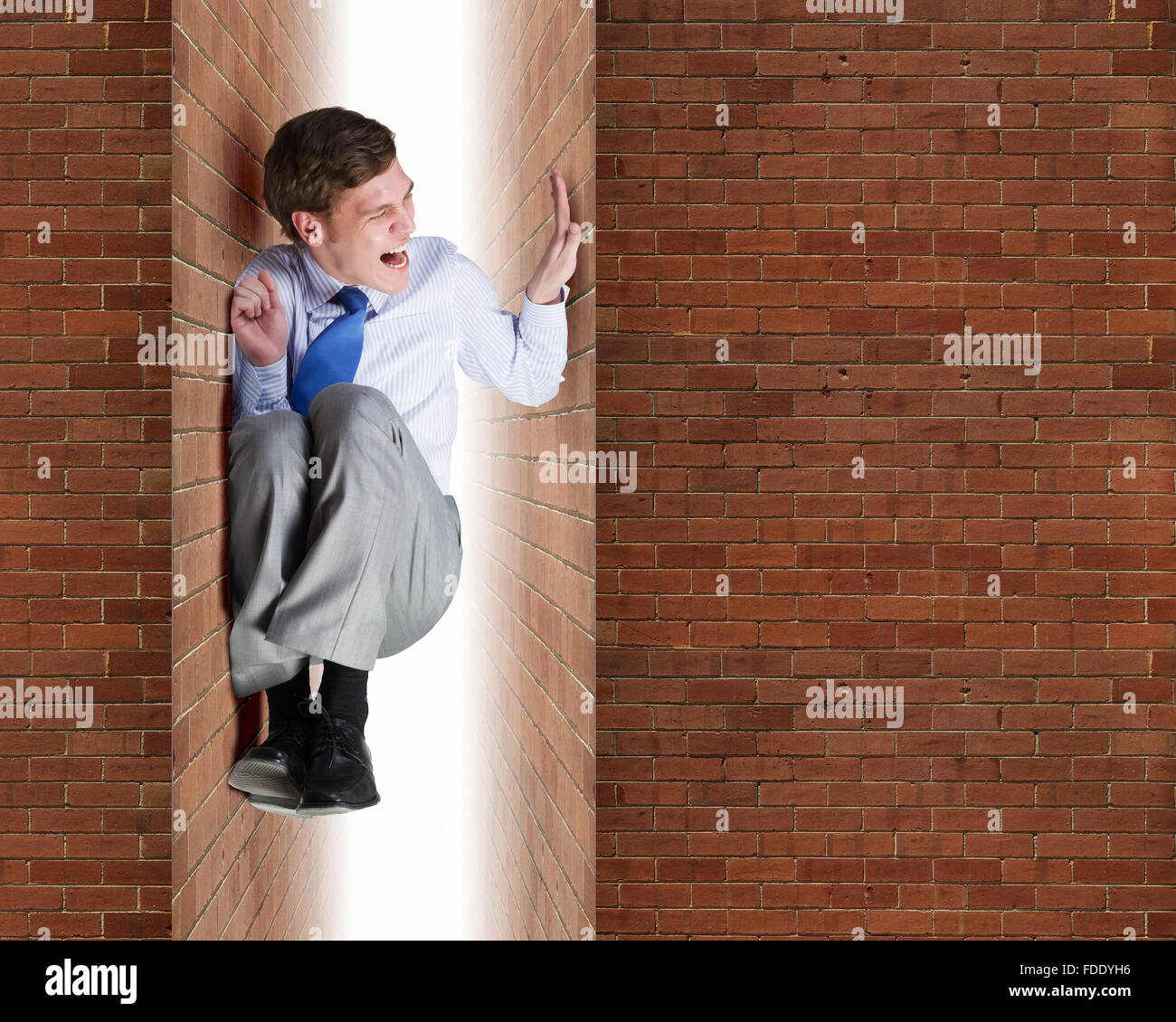 Young troubled businessman trapped between two walls Stock Photo Alamy