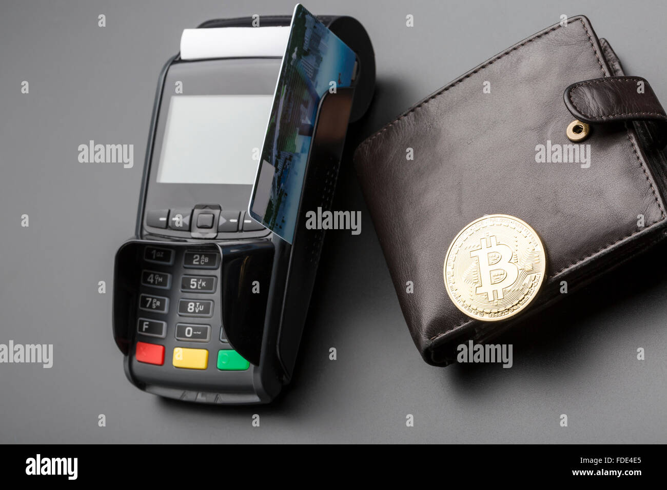 Bitcoin,bank POS-terminal and credit card.Over black background Stock Photo