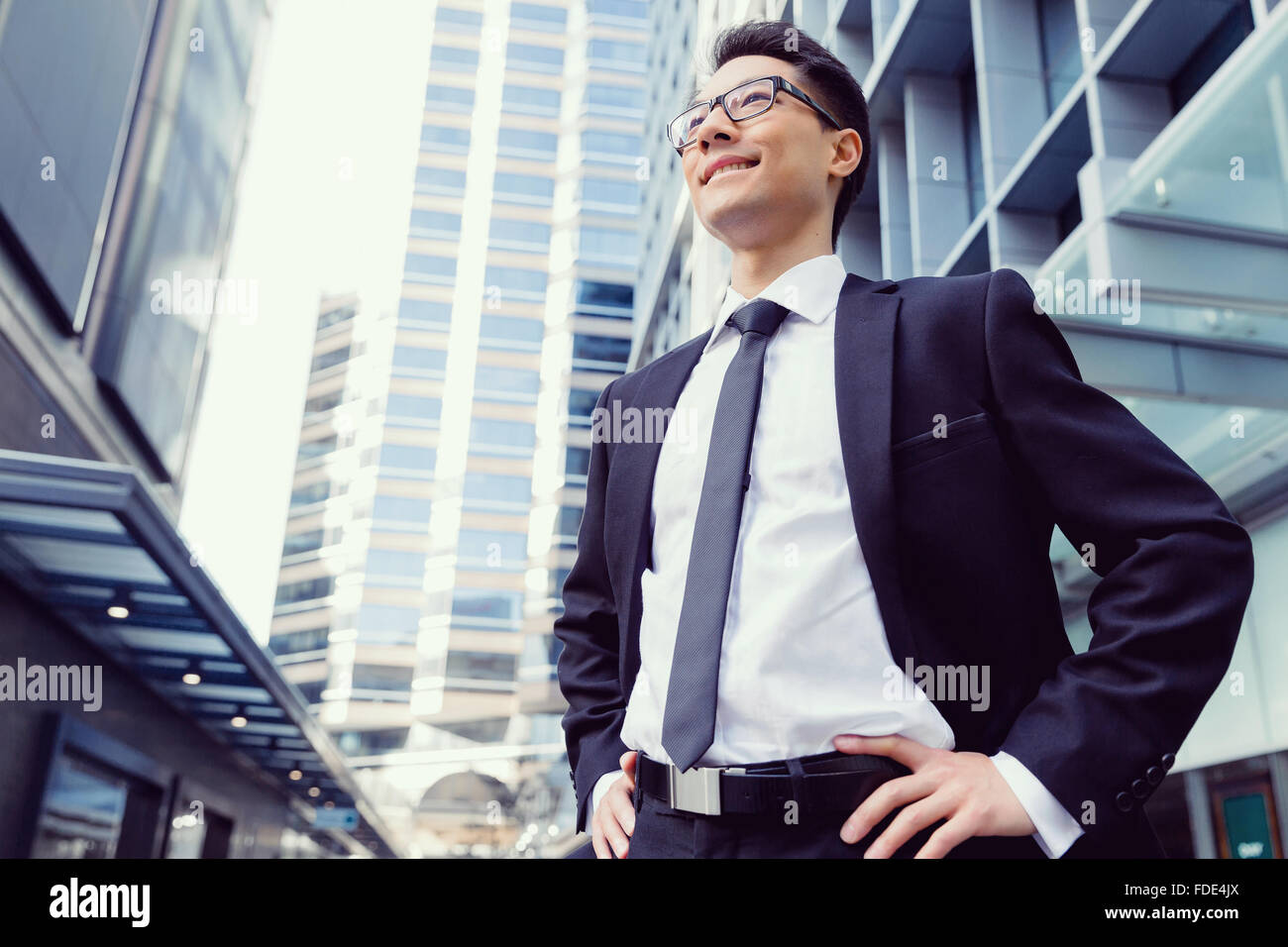 Businessman standing outdoors in city business district Stock Photo - Alamy