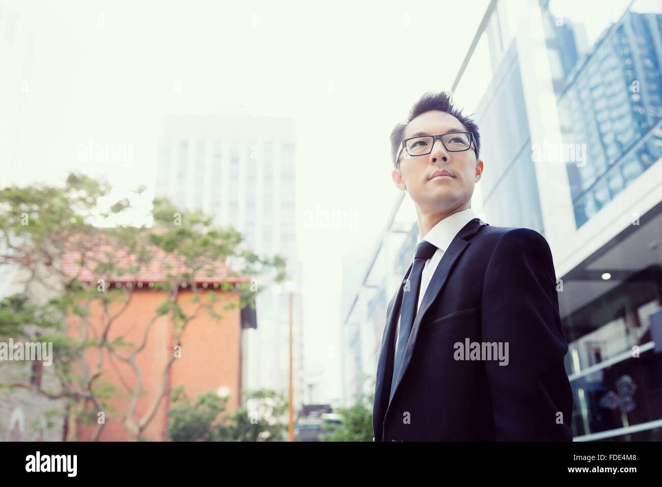Businessman standing outdoors in city business district Stock Photo - Alamy