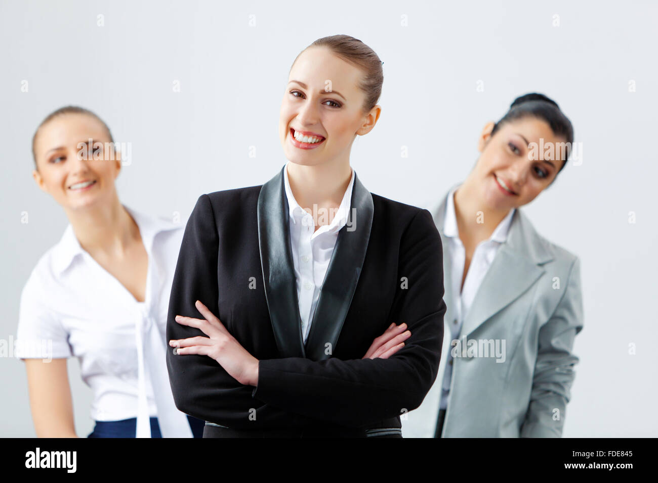 Image of three young businesspeople laughing joyfully Stock Photo - Alamy