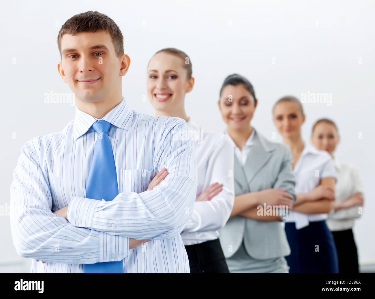 Group of businesspeople smiling standing with arms crossed Stock Photo ...