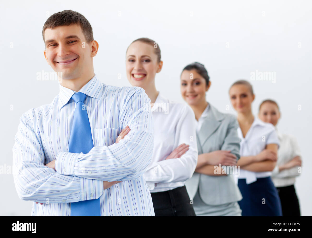 Group of businesspeople smiling standing with arms crossed Stock Photo ...