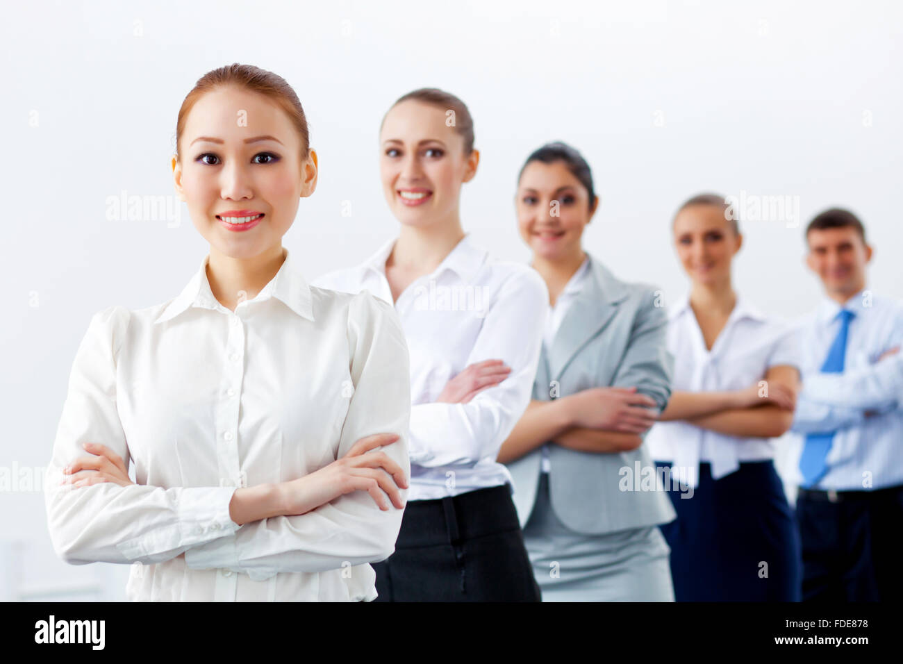 Group of businesspeople smiling standing with arms crossed Stock Photo ...