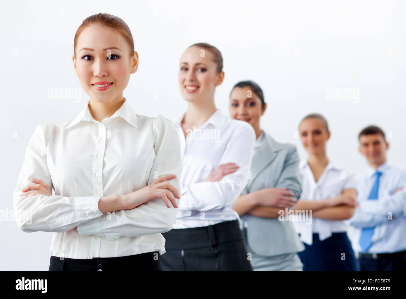 Group of businesspeople smiling standing with arms crossed Stock Photo ...