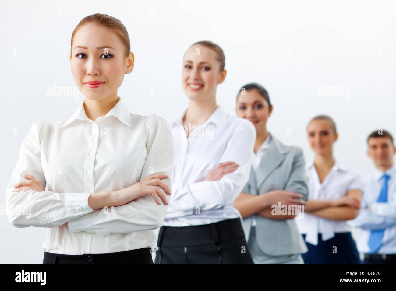 Group of businesspeople smiling standing with arms crossed Stock Photo ...