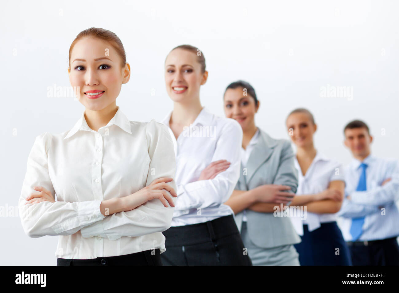 Group of businesspeople smiling standing with arms crossed Stock Photo ...