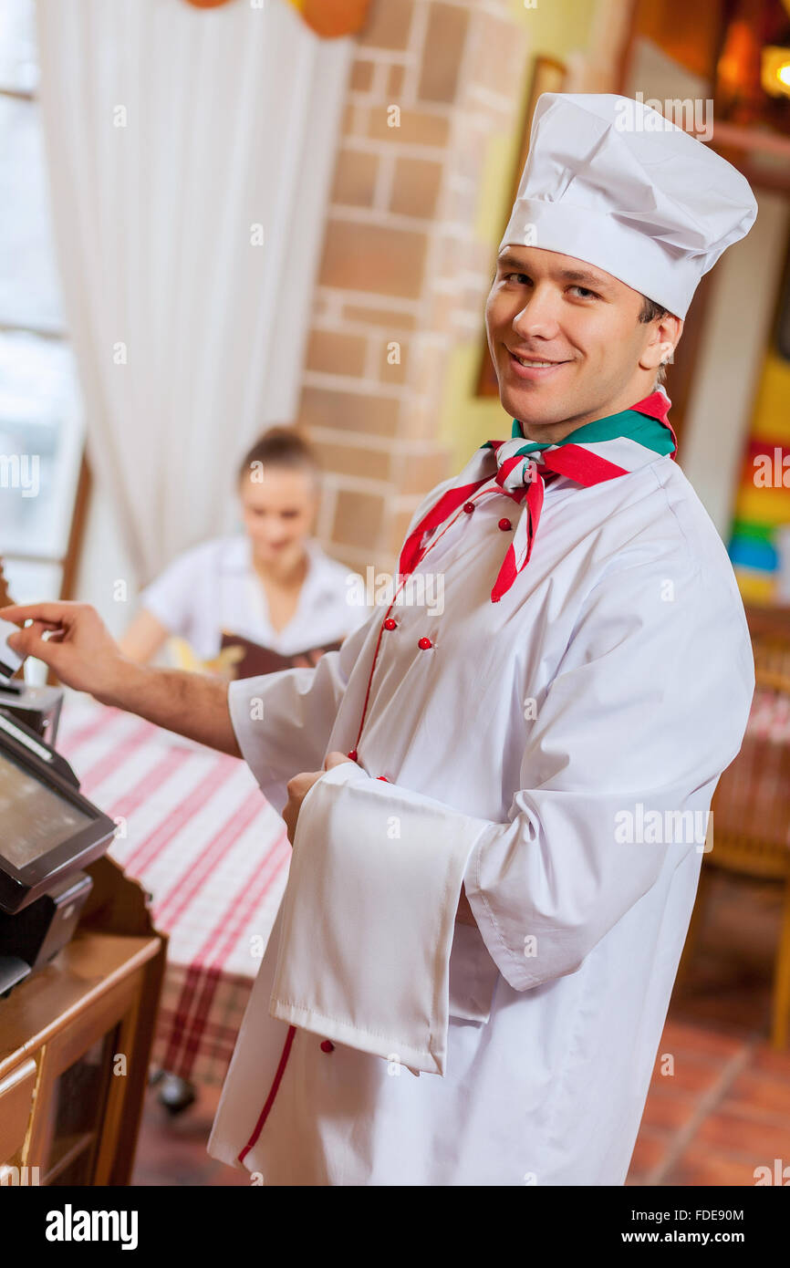 Image of handsome chef inserting card in terminal Stock Photo - Alamy