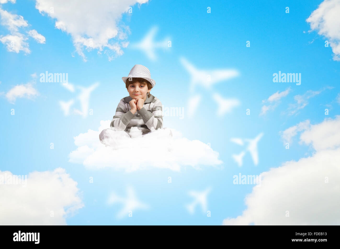 Image of little boy sitting on clouds and relaxing Stock Photo - Alamy