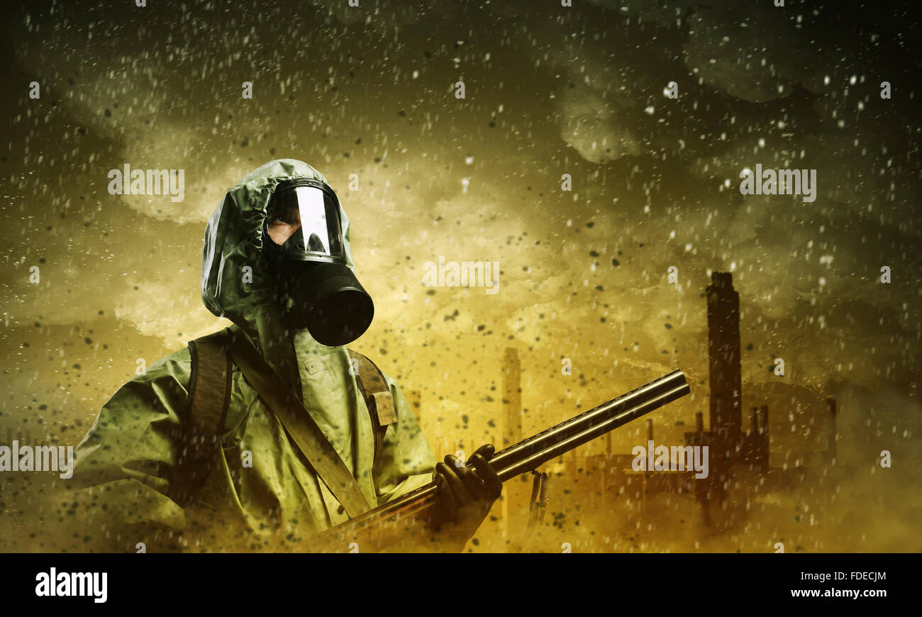 Man in gas mask and camouflage holding gun. Disaster concept Stock