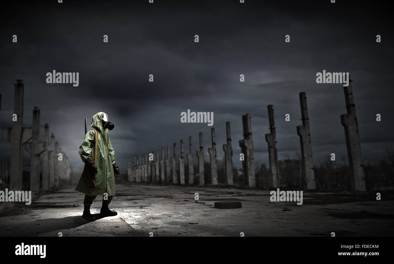 Man in gas mask and camouflage holding gun. Disaster concept Stock Photo