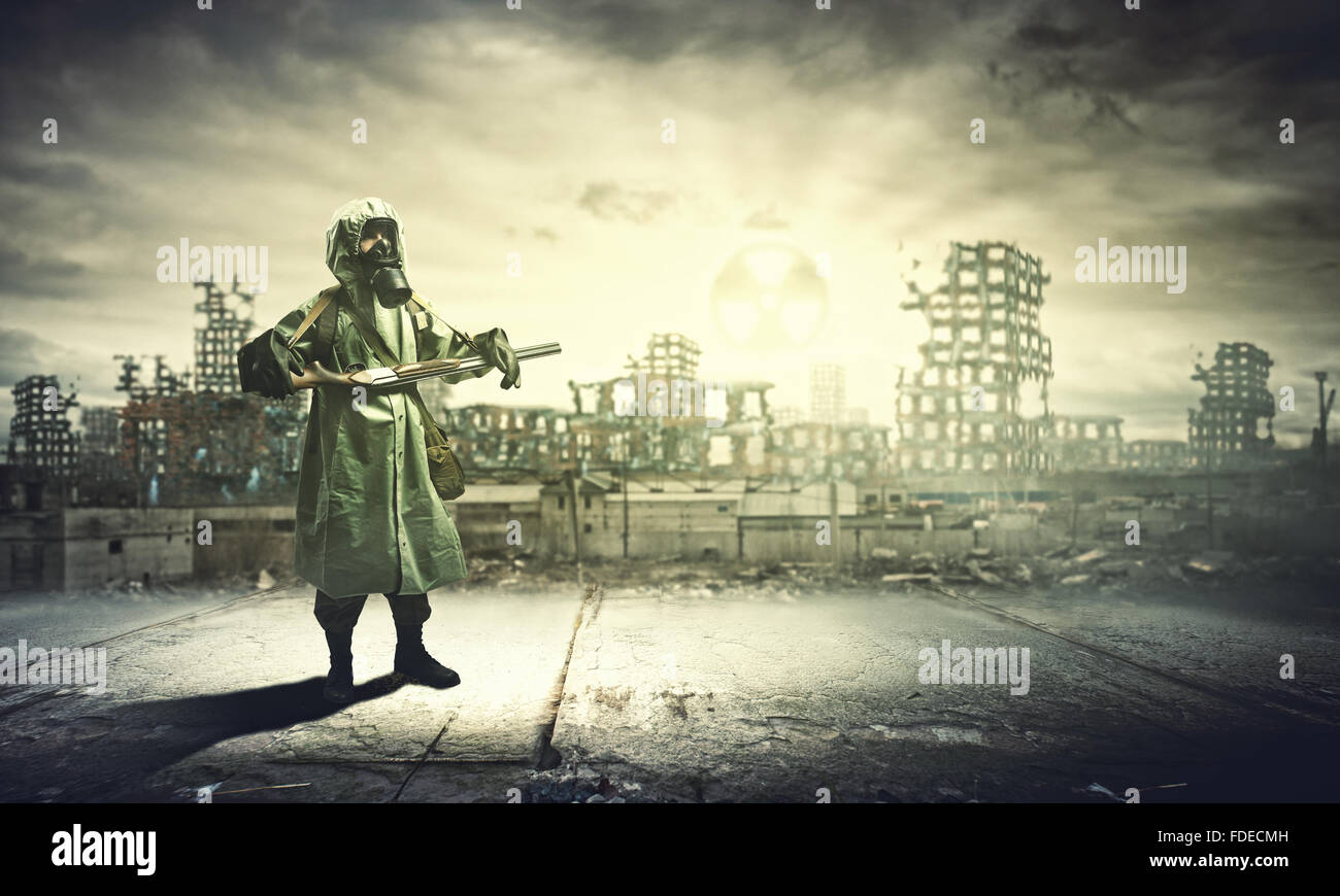 Man in gas mask and camouflage holding gun. Disaster concept Stock Photo