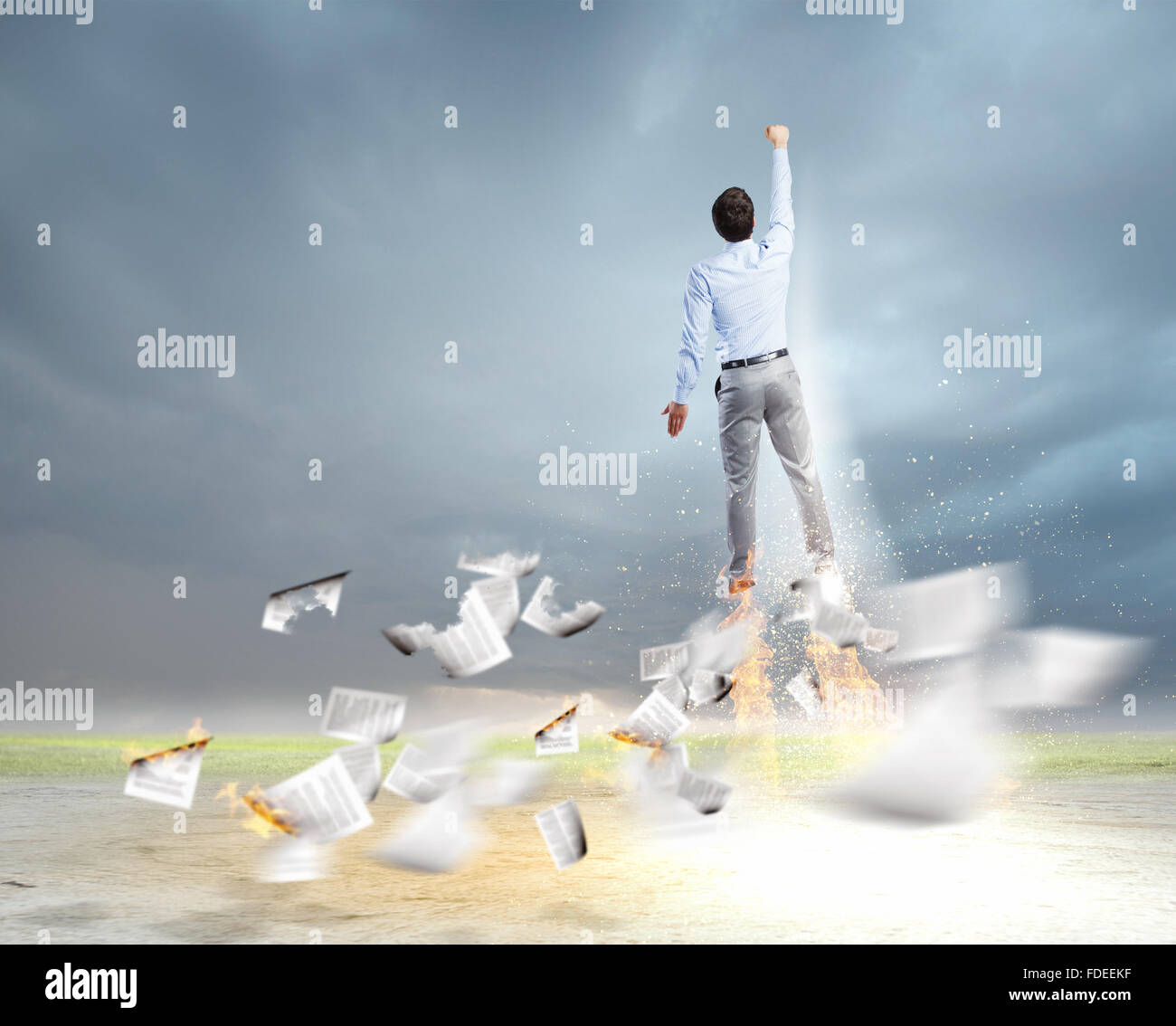 Rear view of businessman superhero flying up in sky Stock Photo - Alamy