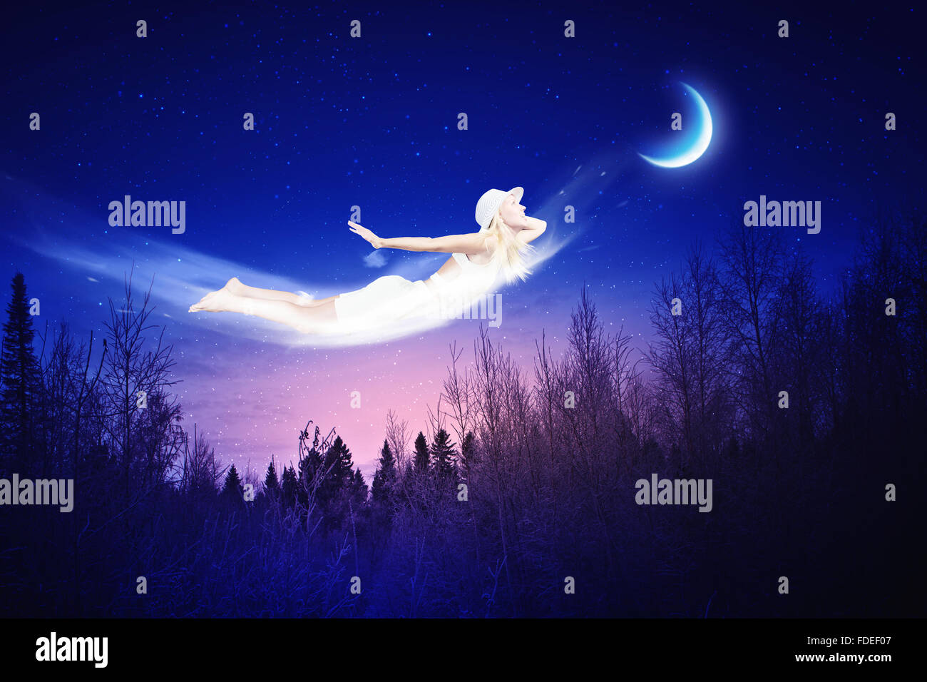 Young blond girl flying in night sky Stock Photo - Alamy