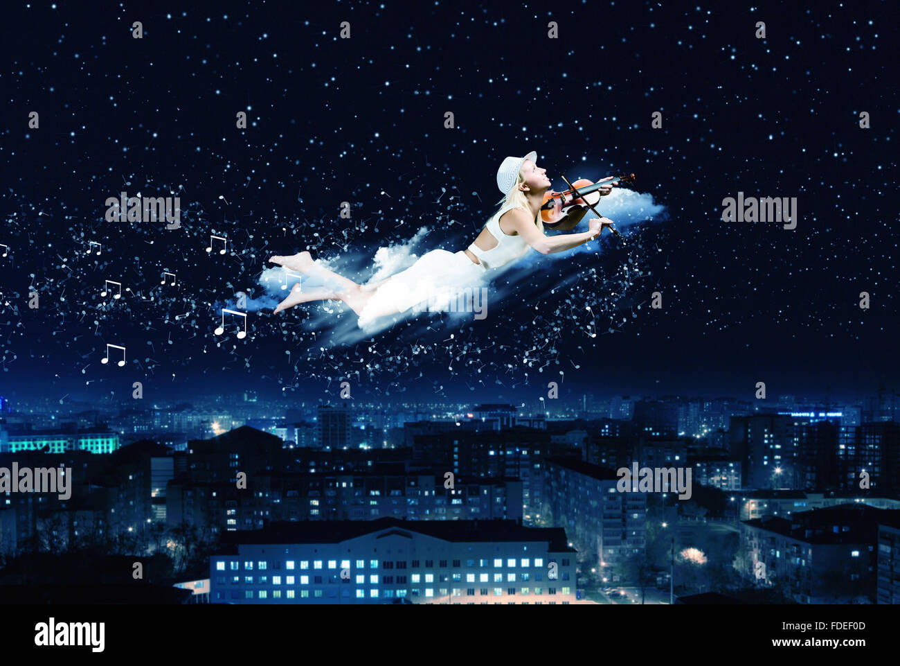 Young blond girl flying in night sky Stock Photo - Alamy