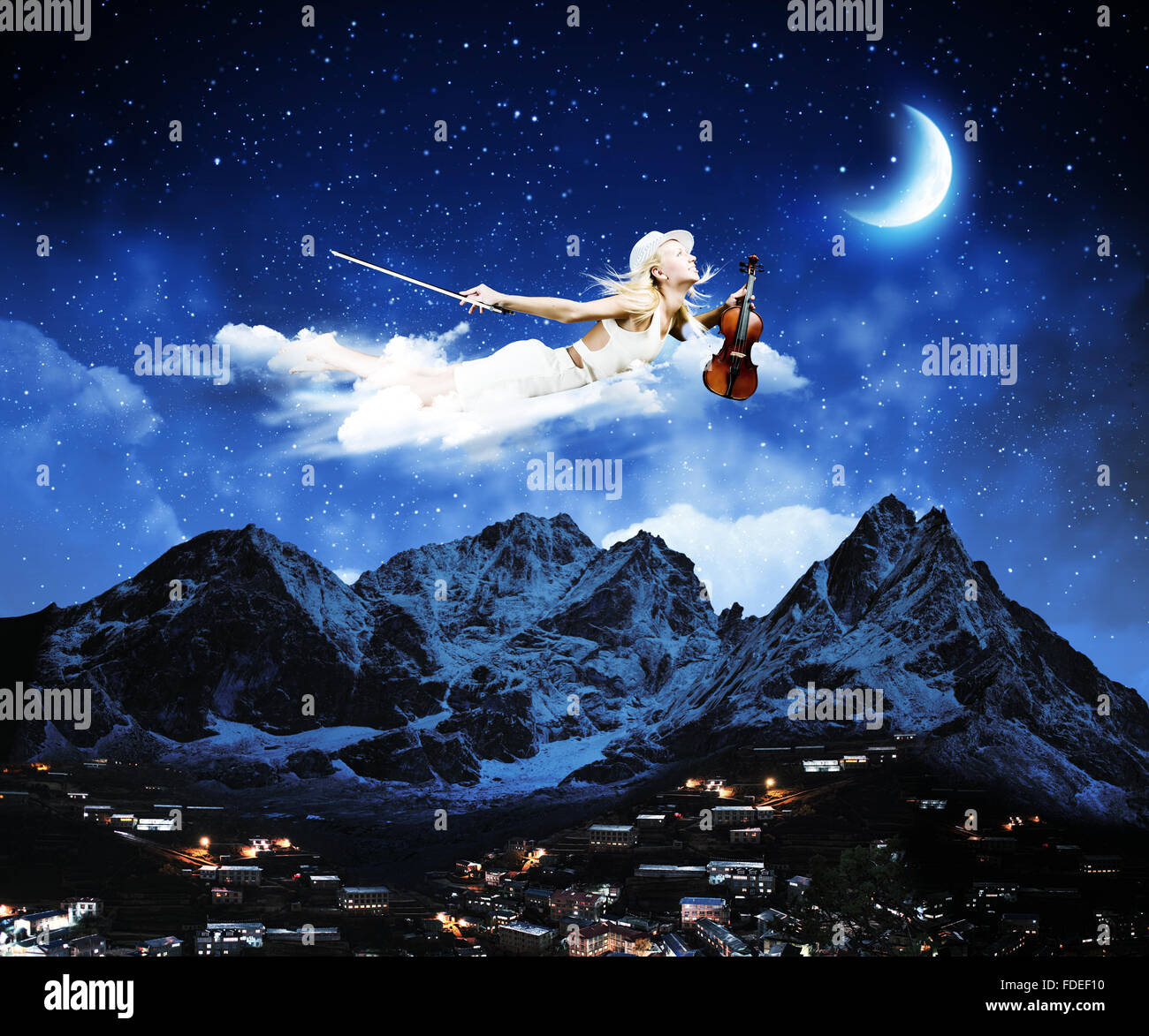 Young blond girl flying in night sky Stock Photo - Alamy