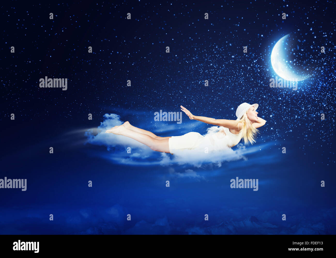 Young blond girl flying in night sky Stock Photo - Alamy