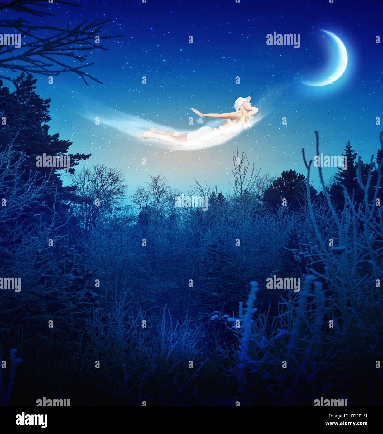 Young blond girl flying in night sky Stock Photo - Alamy