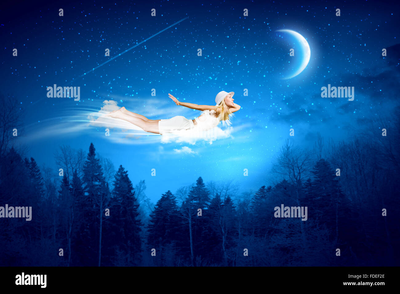 Young blond girl flying in night sky Stock Photo - Alamy