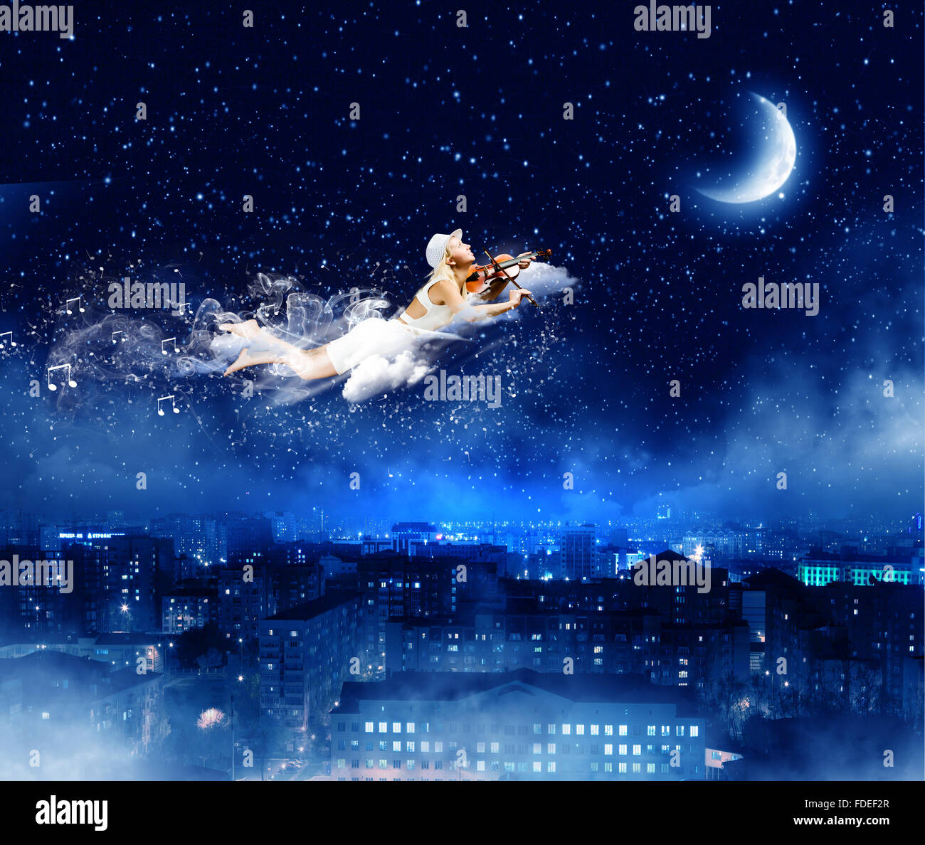 Young blond girl flying in night sky Stock Photo - Alamy