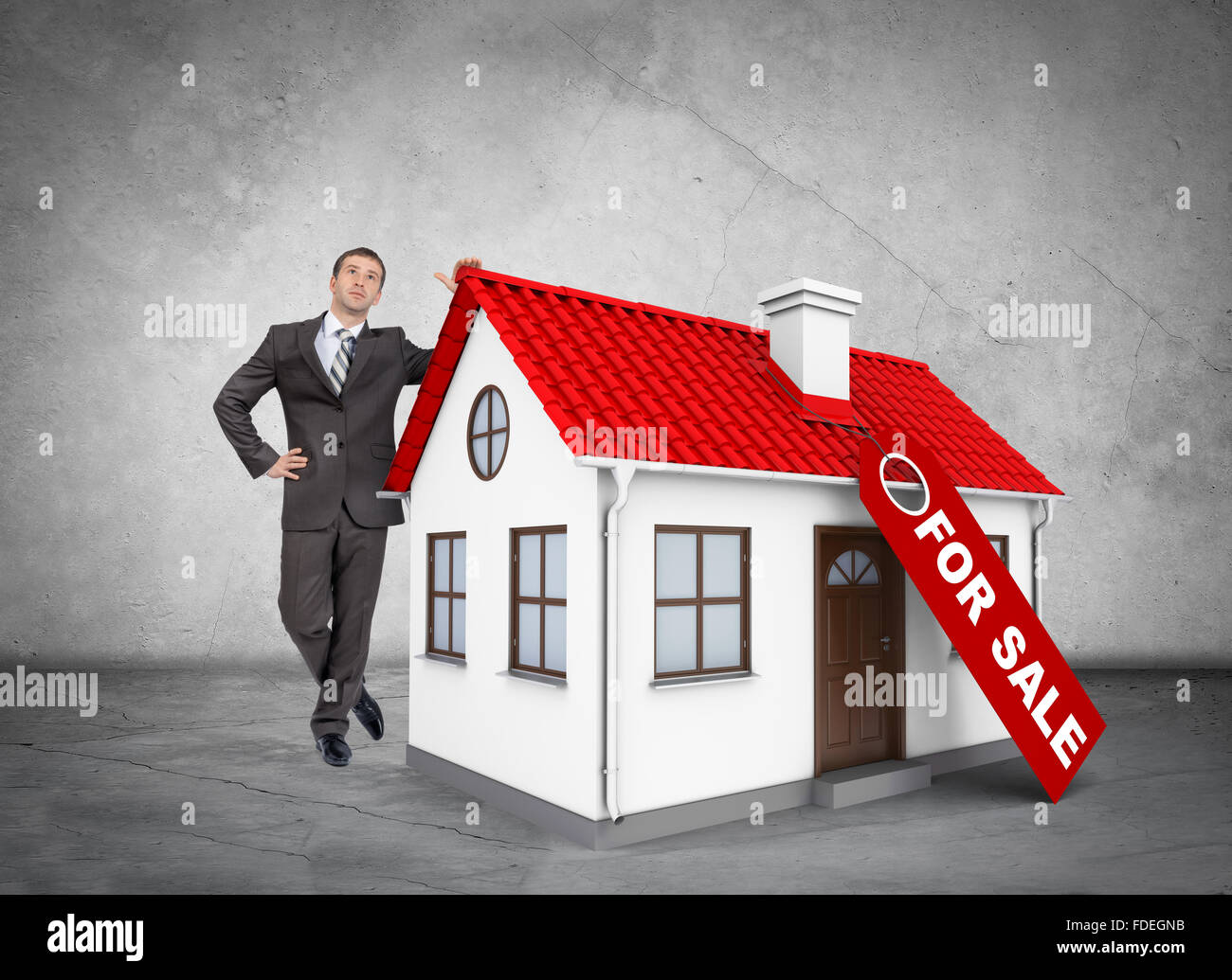 Businessman with house for sale Stock Photo - Alamy