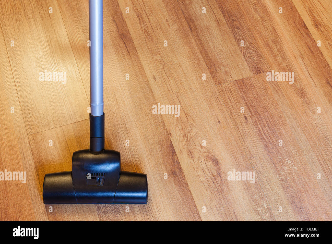 Front View Of Vacuuming Laminate Floor By Vacuum Cleaner At Home Front View Of Vacuuming Laminate Floor By Vacuum Cleaner At Home