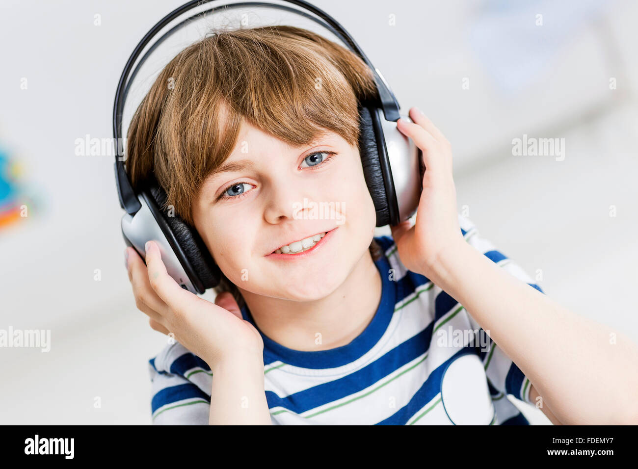 Cute boy wearing headphones and enjoying music Stock Photo - Alamy