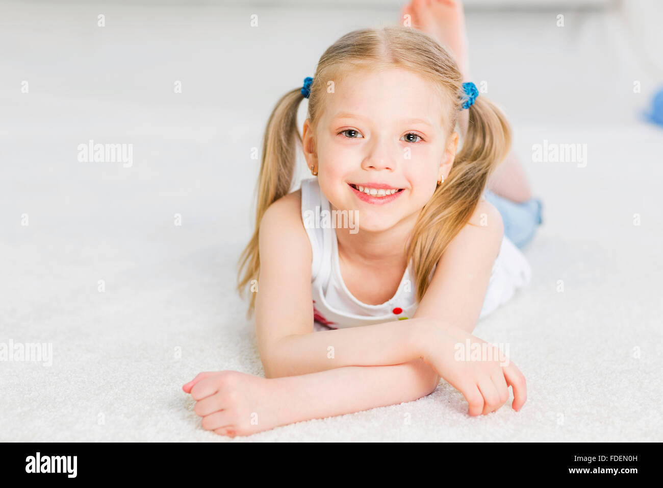Happy girl lying on floor hi-res stock photography and images - Alamy